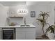 Modern wet bar with sink, shelving, and wine cooler at 16930 E Wagontrail Pkwy, Aurora, CO 80015