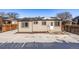 Rear view of house with snow-covered yard and patio at 16930 E Wagontrail Pkwy, Aurora, CO 80015