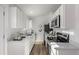 Modern white kitchen with stainless steel appliances at 16930 E Wagontrail Pkwy, Aurora, CO 80015