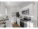 Clean and bright kitchen with white cabinets and stainless steel appliances at 16930 E Wagontrail Pkwy, Aurora, CO 80015