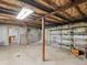 Unfinished basement with exposed beams, shelves, and ample storage space at 6310 Tennyson St, Arvada, CO 80003