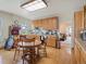 Spacious kitchen area including wood cabinets and a dining space at 6310 Tennyson St, Arvada, CO 80003