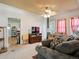 Cozy living room featuring comfortable seating and a ceiling fan for added comfort at 6310 Tennyson St, Arvada, CO 80003