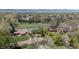 Scenic aerial view of houses with mature trees and a lush green landscape with mountains in the distance at 1322 Wicklow St, Boulder, CO 80303