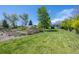 A lush green lawn stretches to the edge of a lovely and private garden area at 1322 Wicklow St, Boulder, CO 80303