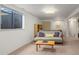 Versatile finished basement featuring a comfortable sofa, wooden shelving and an adjacent flex space at 1322 Wicklow St, Boulder, CO 80303