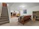 Finished basement with a cozy seating area, brick fireplace, and staircase leading to the upper level at 1322 Wicklow St, Boulder, CO 80303
