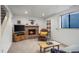 Cozy basement space with a brick fireplace, comfortable seating, and natural light from a window at 1322 Wicklow St, Boulder, CO 80303