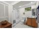 Bright bathroom with a tub-shower, classic black and white tile, and ample storage space at 1322 Wicklow St, Boulder, CO 80303