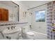Traditional bathroom with white tile, patterned accents, vanity, and tub-shower combination at 1322 Wicklow St, Boulder, CO 80303