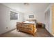 Well-lit bedroom featuring a wood bed frame, neutral carpet, and a window for natural light at 1322 Wicklow St, Boulder, CO 80303