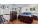 Comfortable bedroom with hardwood floors, ample natural light from multiple windows, and classic wood furniture at 1322 Wicklow St, Boulder, CO 80303