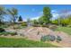 Picture of a landscaped garden area with multiple raised beds and budding tulip flowers at 1322 Wicklow St, Boulder, CO 80303
