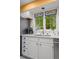 Bright kitchen with white cabinets, stainless steel appliances, and a view to the backyard at 1322 Wicklow St, Boulder, CO 80303
