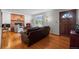 Cozy living room featuring hardwood floors, a brick fireplace, and a comfortable seating arrangement at 1322 Wicklow St, Boulder, CO 80303
