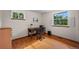 Bright office space with hardwood floors, a wooden desk, and two windows providing plenty of natural light at 1322 Wicklow St, Boulder, CO 80303