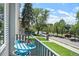 Charming balcony view features a cozy seating area and overlooks the street, filled with lush trees at 2726 Federal Blvd # 1, Denver, CO 80211