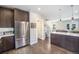 Open-concept kitchen features modern appliances, breakfast bar, and sleek countertops, enhancing the home's contemporary appeal at 2726 Federal Blvd # 1, Denver, CO 80211