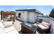 Relax on this rooftop deck with comfortable seating, a modern fire pit, and views, perfect for outdoor relaxation at 2726 Federal Blvd # 1, Denver, CO 80211
