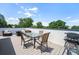 Enjoy outdoor dining on this rooftop deck with a glass table, seating for six, and a grill, ideal for entertaining at 2726 Federal Blvd # 1, Denver, CO 80211