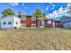 Expansive backyard featuring a shed and the rear of the brick home, with sliding glass doors and an outdoor cooking area at 17769 E Iowa Dr, Aurora, CO 80017