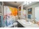 Bathroom featuring colorful shower curtain art, single sink vanity, and modern fixtures at 16737 Lake Helen Blvd, Mead, CO 80542