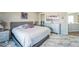Spacious bedroom featuring a comfortable bed, marble flooring, and a dresser with decorative accents at 16737 Lake Helen Blvd, Mead, CO 80542