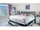 Modern bedroom with a sleek platform bed, stylish decor, and plenty of natural light from the window at 16737 Lake Helen Blvd, Mead, CO 80542