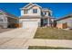 Traditional two-story home with a two car garage and a well manicured lawn at 16737 Lake Helen Blvd, Mead, CO 80542