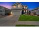 A charming two-story home featuring a two car garage and manicured lawn at 16737 Lake Helen Blvd, Mead, CO 80542