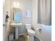 Well-maintained half-bathroom with a pedestal sink, toilet, neutral colors and tile flooring at 16737 Lake Helen Blvd, Mead, CO 80542