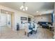 Open-concept living room featuring hardwood floors and ample natural light, seamlessly connected to dining at 16737 Lake Helen Blvd, Mead, CO 80542