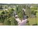 The aerial view reveals a winding driveway leading to the home, surrounded by mature trees and lush greenery at 19235 Wakonda Way, Monument, CO 80132
