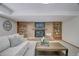 The basement Gathering room features a brick fireplace, built-in bookshelves, and recessed lighting at 19235 Wakonda Way, Monument, CO 80132