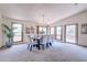 Well-lit dining room featuring large windows and elegant table set for six at 19235 Wakonda Way, Monument, CO 80132