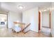 Upstairs hallway featuring wood floors, white walls, and a view of a bedroom at 19235 Wakonda Way, Monument, CO 80132