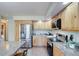 Modern kitchen featuring stainless steel appliances, light wood cabinetry, and stone countertops at 19235 Wakonda Way, Monument, CO 80132