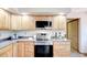 Updated kitchen with stainless steel appliances, light wood cabinets, and modern countertops at 19235 Wakonda Way, Monument, CO 80132