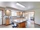 Open kitchen with a central island and view into the adjacent dining room at 19235 Wakonda Way, Monument, CO 80132