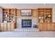 Cozy living room features built-in shelving and a tiled fireplace with mounted television above at 19235 Wakonda Way, Monument, CO 80132