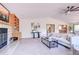 Open living room featuring a fireplace, vaulted ceiling, carpet, and ceiling fan at 19235 Wakonda Way, Monument, CO 80132