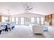 Spacious living room with vaulted ceilings, large windows, carpet, and a dining area at 19235 Wakonda Way, Monument, CO 80132