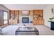 Bright living room featuring a fireplace with built-in shelving and a glass coffee table at 19235 Wakonda Way, Monument, CO 80132