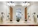 This main bathroom features a double vanity with a large mirror and modern lighting fixtures at 19235 Wakonda Way, Monument, CO 80132