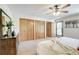 This is a spacious main bedroom featuring a ceiling fan, large closets, and natural light from a window at 19235 Wakonda Way, Monument, CO 80132