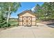 Charming outbuilding with double doors and concrete floor, perfect for storage or as a workshop at 19235 Wakonda Way, Monument, CO 80132