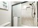 The shower features decorative tile, a sliding glass door, and a mounted shower head at 19235 Wakonda Way, Monument, CO 80132