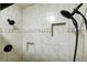 The tile shower features a built-in shampoo shelf and dual shower heads at 19235 Wakonda Way, Monument, CO 80132