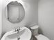 Small bathroom with a round mirror and white vanity at 7440 Lowell Blvd # B, Westminster, CO 80030