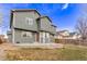 Backyard with a circular patio, green grass and back exterior of home at 4630 E 135Th Way, Thornton, CO 80241